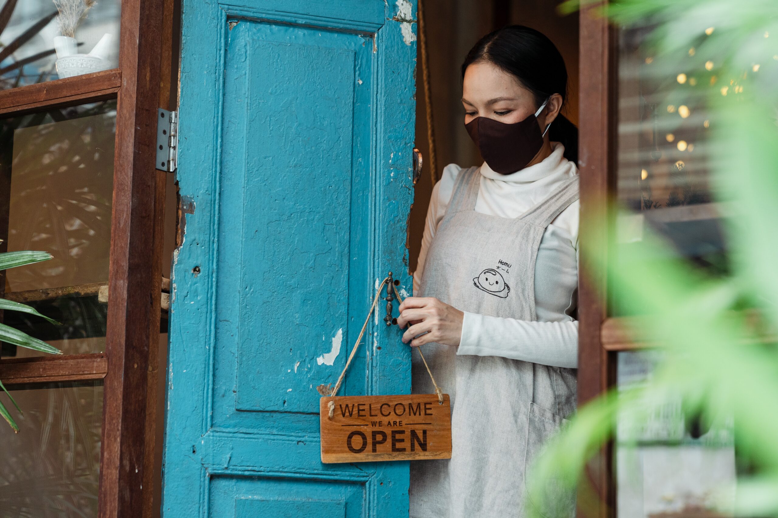 Photo Of Woman Putting Wooden Welcome Sign On Doorknob 4473094