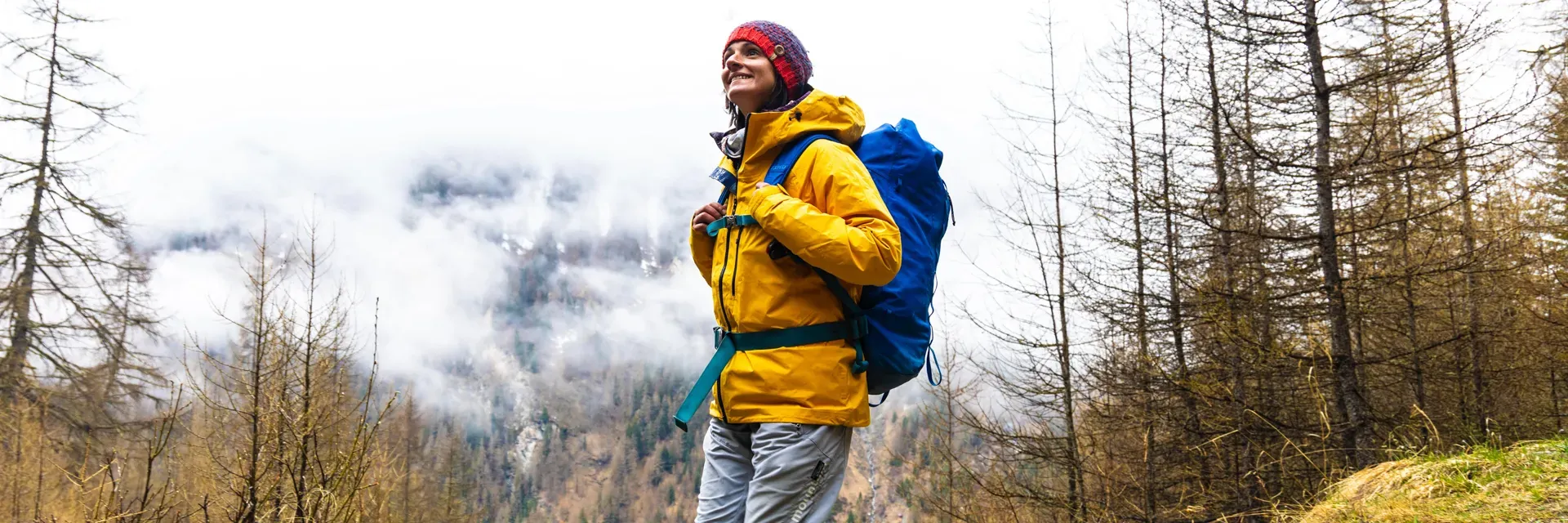 Woman Walking In Forest Wearing Jacket Backpack Nikwax 1920px